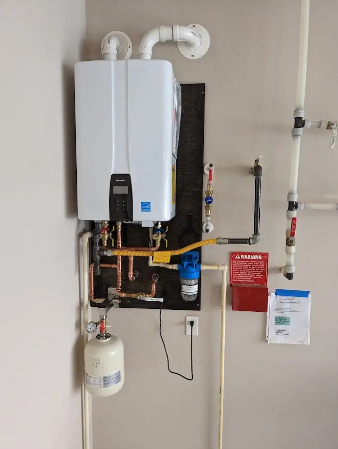Professional plumber installing copper piping in a Glen Ellyn home